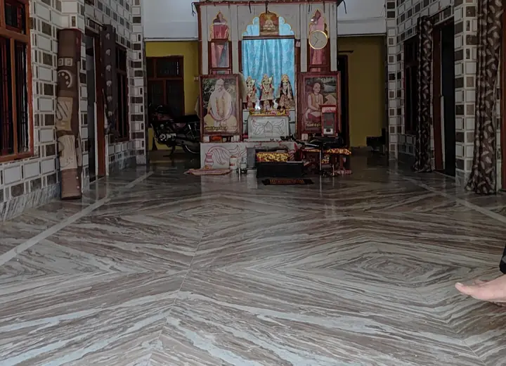 Family room with maroon floral bedsheet